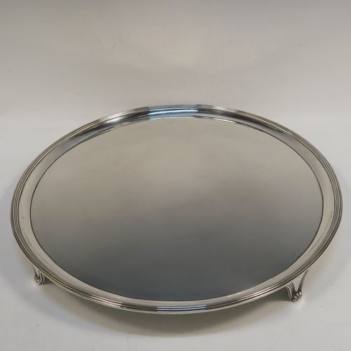 A very handsome Antique Georgian Sterling Silver salver, having an applied reeded border, a plain ground, and sitting on four cast reeded feet. This beautiful antique silver salver was made by John Hutson of London in 1792. The dimensions of this fine hand-made antique silver salver are diameter 35.5 cms (14 inches), and it weighs approx. 1,214g (39 troy ounces).  