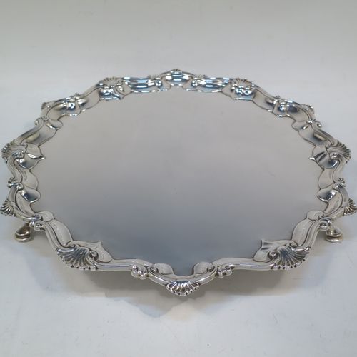 A very elegant Antique Georgian Sterling Silver salver, having an applied shell and scroll border, a plain ground, and sitting on three cast hoof feet. Made by Richard Rugg of London in 1760. The dimensions of this fine hand-made antique silver salver are diameter 33 cms (13 inches), height 4 cms (1.5 inches), and it weighs approx. 875g (28 troy ounces)   