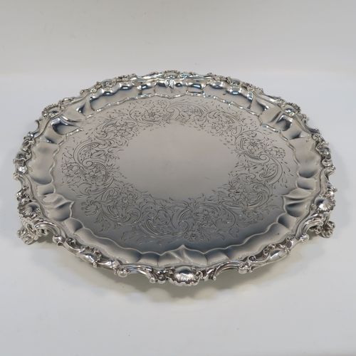 A beautiful Antique early Victorian Sterling Silver salver, having an applied cast shell and scroll border, the ground having hand-chased floral and scroll decoration surrounding a central vacant cartouche, and all sitting on three cast and pierced scroll feet. This fantastic salver was made by the most important 19th century British silversmith Paul Storr of London in 1838. The dimensions of this fine hand-made antique silver salver are diameter 32 cms (12.3 inches), height 4 cms (1.5 inches), and it weighs approx. 1,006g (32.5 troy ounces).   