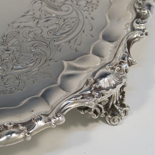 A beautiful Antique early Victorian Sterling Silver salver, having an applied cast shell and scroll border, the ground having hand-chased floral and scroll decoration surrounding a central vacant cartouche, and all sitting on three cast and pierced scroll feet. This fantastic salver was made by the most important 19th century British silversmith Paul Storr of London in 1838. The dimensions of this fine hand-made antique silver salver are diameter 32 cms (12.3 inches), height 4 cms (1.5 inches), and it weighs approx. 1,006g (32.5 troy ounces).   