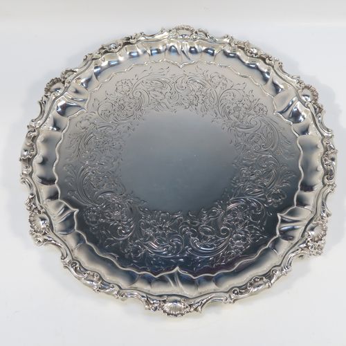 A beautiful Antique early Victorian Sterling Silver salver, having an applied cast shell and scroll border, the ground having hand-chased floral and scroll decoration surrounding a central vacant cartouche, and all sitting on three cast and pierced scroll feet. This fantastic salver was made by the most important 19th century British silversmith Paul Storr of London in 1838. The dimensions of this fine hand-made antique silver salver are diameter 32 cms (12.3 inches), height 4 cms (1.5 inches), and it weighs approx. 1,006g (32.5 troy ounces).   