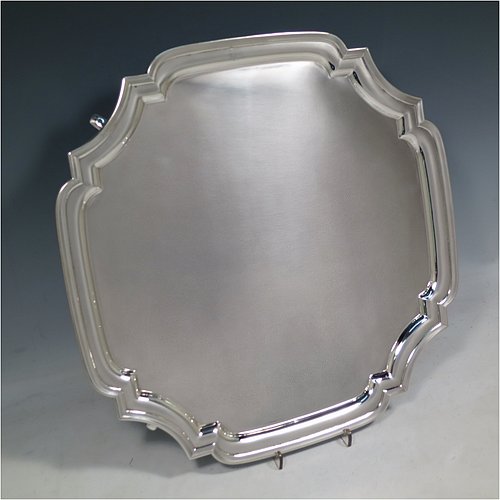 A Sterling Silver salver, having a square cut-corner body, with a plain burnished ground, an applied cut-corner border, and sitting on four cast hoof feet. Made by Robert Pringle of London in 1935. The dimensions of this fine hand-made silver salver are 34 cms (13.5 inches) square, and it weighs approx. 1,116g (36 troy ounces).    