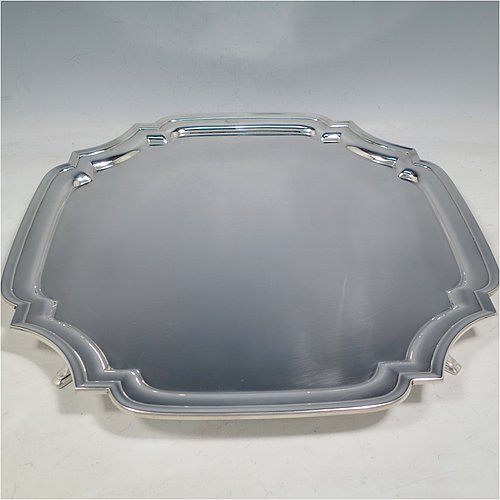 A Sterling Silver salver, having a square cut-corner body, with a plain burnished ground, an applied cut-corner border, and sitting on four cast hoof feet. Made by Robert Pringle of London in 1935. The dimensions of this fine hand-made silver salver are 34 cms (13.5 inches) square, and it weighs approx. 1,116g (36 troy ounces).    