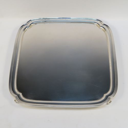 A very elegant Sterling Silver salver, having a square body with shaped and cut corners, a plain burnished ground, an applied reeded border, and sitting on four cast scroll feet. This handsome silver salver was made by S. Blankensee and Sons Ltd., of Birmingham in 1937. The dimensions of this fine hand-made silver salver are 34.5 cms (13.5 inches) square, and it weighs approx. 1,210g (39 troy ounces).  