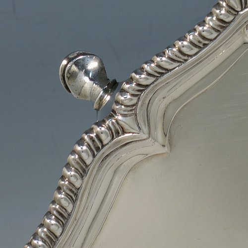 A very handsome Antique Georgian Irish Sterling Silver salver, having an applied shaped gadroon border, a plain ground with a hand-engraved armorial central crest and Latin motto, and sitting on four cast hoof feet. This elegant Irish antique silver salver was made in Dublin, Ireland, in 1796. The dimensions of this fine hand-made antique silver salver are diameter 36 cms (14.25 inches), and it weighs approx. 1,190g (38 troy ounces).    