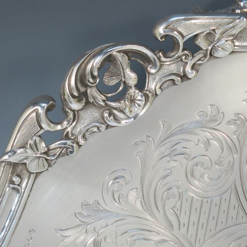 A very pretty Antique Victorian Silver Plated large salver, having an applied cast scroll border with floral decoration and piercing, with a ground having hand-engraved floral and scroll decoration surrounding a central vacant round cartouche, and all sitting on three cast scroll  feet. Made (poss.) by James Dixon And Sons of Sheffield in ca. 1860. The dimensions of this fine hand-made antique silver-plated salver are diameter 48 cms (19 inches), and height 5 cms (2 inches).  