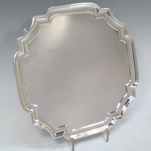 A very handsome Sterling Silver salver, having a square cut-corner body, with a plain burnished ground, an applied cut-corner border, and sitting on four cast scroll feet. Made by Goldsmiths and Silversmiths of London in 1928. The dimensions of this fine hand-made silver salver are 30.5 cms (12 inches) square, and it weighs approx. 958g (31 troy ounces).  