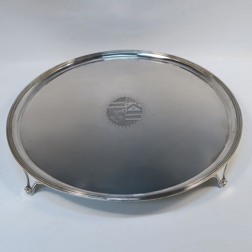 A large and very handsome Antique Georgian Sterling Silver salver, having a round body with an applied reeded border, a plain ground with a hand-engraved full armorial central crest, and sitting on four cast reeded and flanged feet. This elegant antique silver salver was made by Charles Hougham of London in 1790. The dimensions of this fine hand-made antique silver salver are diameter 38 cms (15 inches), and it weighs approx. 1,440g (46.5 troy ounces).   