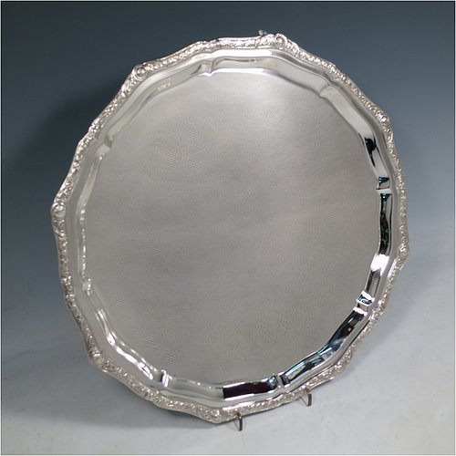 A Sterling Silver salver, having an applied shaped cast Celtic or Cymric border, a plain ground, and sitting on four cast hoof feet. Made by Roberts & Belk of Sheffield in 1988. The dimensions of this fine hand-made silver salver are diameter 32 cms (12.5 inches), and it weighs approx. 900g (29 troy ounces).    