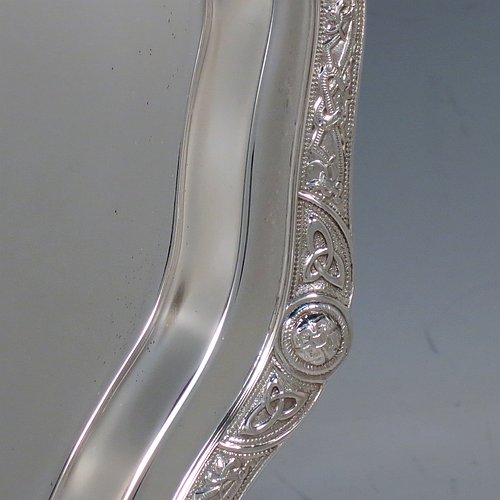 A Sterling Silver salver, having an applied shaped cast Celtic or Cymric border, a plain ground, and sitting on four cast hoof feet. Made by Roberts & Belk of Sheffield in 1988. The dimensions of this fine hand-made silver salver are diameter 32 cms (12.5 inches), and it weighs approx. 900g (29 troy ounces).    