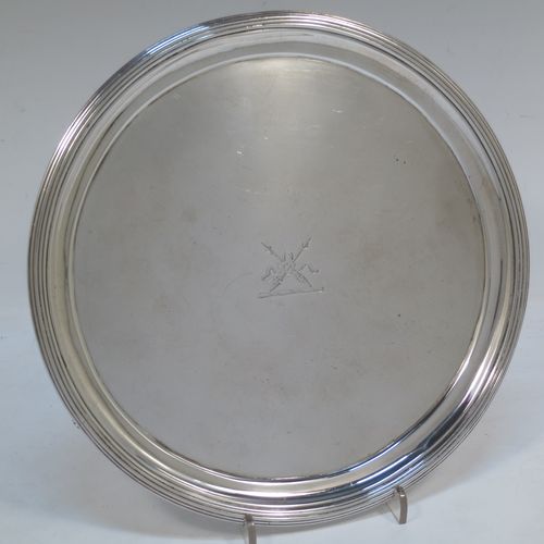 A very handsome Antique Georgian Sterling Silver George IV salver, having a round body with plain burnished ground, an applied reeded border, and sitting on three cast flange feet. Made by Joseph Craddock and William Ker Reid of London in 1824. The dimensions of this fine hand-made antique silver salver are diameter 21.5 cms (8.5 inches), height 3 cms (1.25 inches), and it weighs approx. 397g (12.8 troy ounces). Please note that this item is crested.