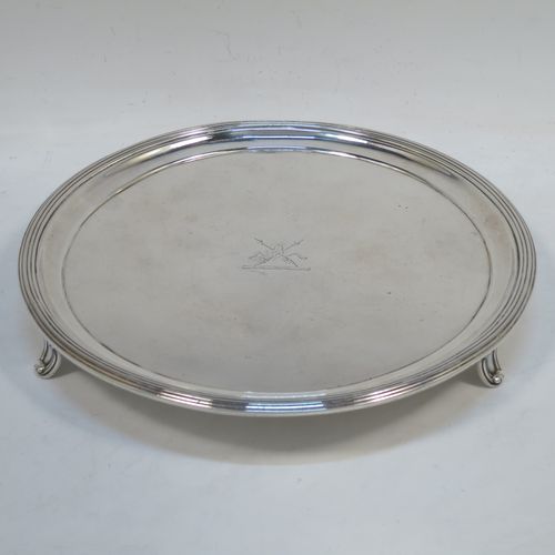 A very handsome Antique Georgian Sterling Silver George IV salver, having a round body with plain burnished ground, an applied reeded border, and sitting on three cast flange feet. Made by Joseph Craddock and William Ker Reid of London in 1824. The dimensions of this fine hand-made antique silver salver are diameter 21.5 cms (8.5 inches), height 3 cms (1.25 inches), and it weighs approx. 397g (12.8 troy ounces). Please note that this item is crested.