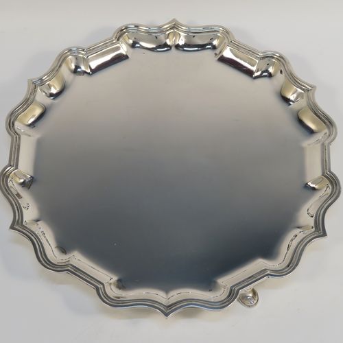 A very handsome Antique Edwardian Scottish Sterling Silver salver, having a round body, with a plain burnished ground, an applied Bath edged border, and sitting on three cast hoof feet. This elegant silver salver was made by Brook and Son of Edinburgh in 1904. The dimensions of this fine hand-made antique silver salver are diameter 26 cms (10.25 inches), and it weighs approx. 555g (18 troy ounces).   