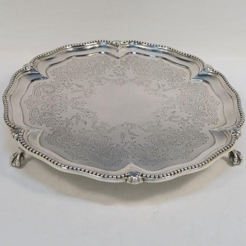 A very pretty Antique Victorian Sterling Silver salver, having an applied and shaped bead-edged border, a hand-engraved ground with floral, scroll, and bird decoration, and sitting on three cast claw and ball feet. This beautiful antique silver salver was made by Stephen Smith of London in 1876. The dimensions of this fine hand-made silver salver are diameter 27.5 cms (10.75 inches), and it weighs approx. 792g (25.5 troy ounces).  