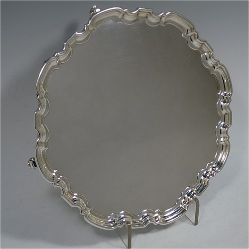 A very handsome Scottish Sterling Silver salver, having a round body, with a plain burnished ground, an applied Chippendale border, and sitting on four cast scroll feet. Made by Davidson, Henderson, and Sorley of Glasgow in 1933. The dimensions of this fine hand-made Scottish silver salver are diameter 26 cms (10.25 inches), and it weighs approx. 618g (20 troy ounces).    