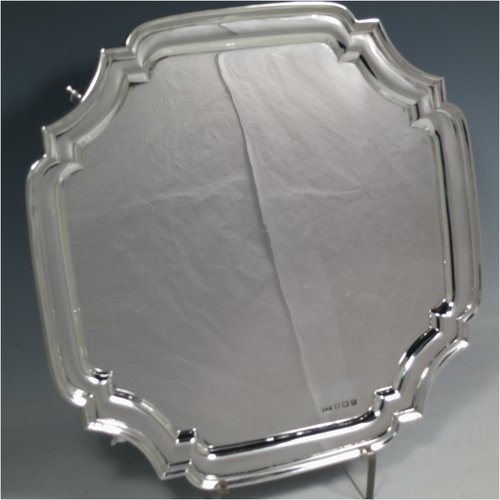 A Sterling Silver salver, having a square cut-corner body, with a plain burnished ground, an applied cut-corner border, and sitting on four cast scroll feet. Made by Emile Viner of Sheffield in 1938. The dimensions of this fine hand-made silver salver are 26.5 cms (10.5 inches) square, and it weighs approx. 547g (17.6 troy ounces).   