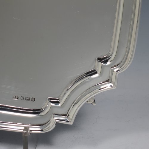 A Sterling Silver salver, having a square cut-corner body, with a plain burnished ground, an applied cut-corner border, and sitting on four cast scroll feet. Made by Emile Viner of Sheffield in 1938. The dimensions of this fine hand-made silver salver are 26.5 cms (10.5 inches) square, and it weighs approx. 547g (17.6 troy ounces).   