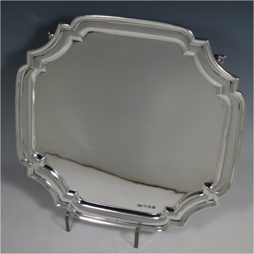 A Sterling Silver salver, having a square cut-corner body, with a plain burnished ground, an applied cut-corner border, and sitting on four cast scroll feet. Made by Emile Viner of Sheffield in 1938. The dimensions of this fine hand-made silver salver are 26.5 cms (10.5 inches) square, and it weighs approx. 547g (17.6 troy ounces).   