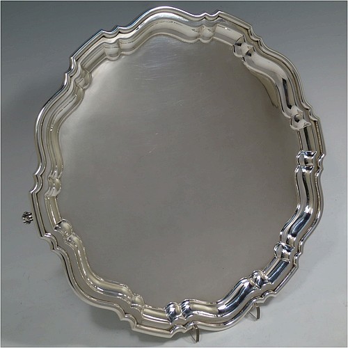 A very handsome Sterling Silver salver, having a round body, with a plain burnished ground, an applied Chippendale border, and sitting on three cast scroll feet. Made by Robert Pringle of London in 1933. The dimensions of this fine hand-made silver salver are diameter 30.5 cms (12 inches), and it weighs approx. 777g (25 troy ounces).    