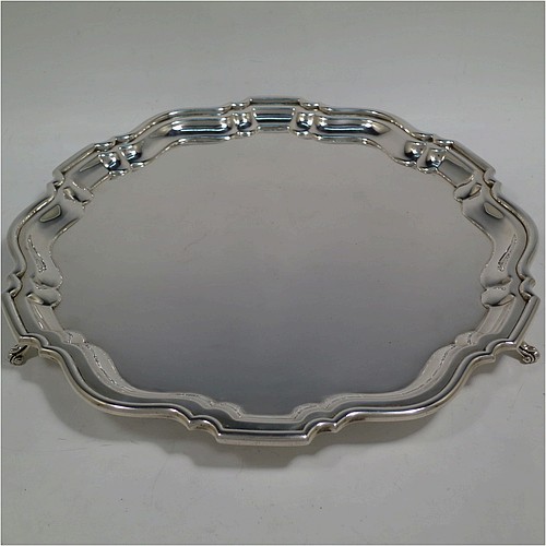 A very handsome Sterling Silver salver, having a round body, with a plain burnished ground, an applied Chippendale border, and sitting on three cast scroll feet. Made by Robert Pringle of London in 1933. The dimensions of this fine hand-made silver salver are diameter 30.5 cms (12 inches), and it weighs approx. 777g (25 troy ounces).    