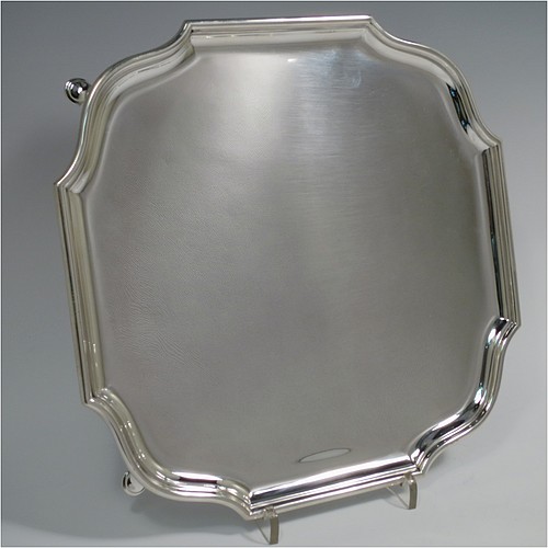 A Sterling Silver salver, having a square body with shaped and cut corners, a plain burnished ground, an applied reeded border, and sitting on four cast hoof feet. Made by Hawksworth Eyre and Co., of London in 1925. The dimensions of this fine hand-made silver salver are 26 cms (10.25 inches) square, and it weighs approx. 809g (26 troy ounces).    