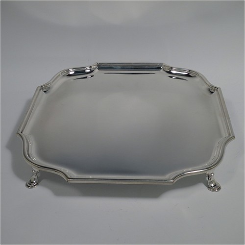 A Sterling Silver salver, having a square body with shaped and cut corners, a plain burnished ground, an applied reeded border, and sitting on four cast hoof feet. Made by Hawksworth Eyre and Co., of London in 1925. The dimensions of this fine hand-made silver salver are 26 cms (10.25 inches) square, and it weighs approx. 809g (26 troy ounces).    