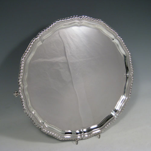 Sterling silver salver, having a shaped gadroon border, plain ground, and sitting on four cast claw and ball feet. Made by Charles Boyton and Sons of Sheffield in 1938. The dimensions of this fine hand-made silver salver are diameter 32 cms (12.5 inches), and it weighs approx. 958g (31 troy ounces).   