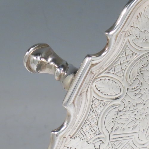 An Antique Georgian Sterling Silver salver, having an applied Chippendale border, a hand-chased ground with floral decoration, and sitting on four cast hoof feet. Made by George Hindmarsh of London in 1738. The dimensions of this fine hand-made silver salver are diameter 25 cms (10 inches), and it weighs approx. 594g (19.2 troy ounces).   