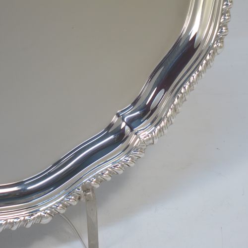 A very handsome Sterling Silver salver, having an applied shaped gadroon border, a plain ground, and sitting on three cast scroll feet. Made by I.S. Greenberg of Birmingham in 1929. The dimensions of this fine hand-made silver salver are diameter 30.5 cms (12 inches), and it weighs approx. 990g (32 troy ounces).   