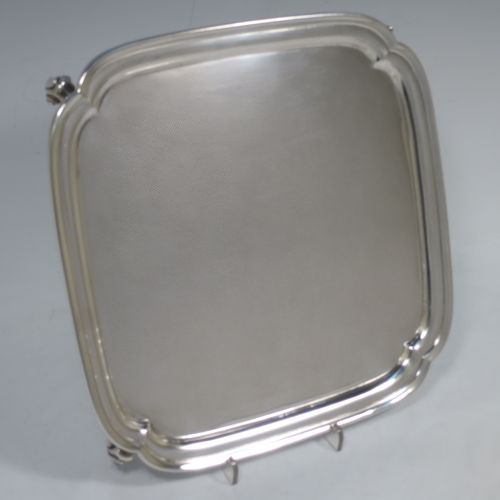 A handsome Sterling Silver salver, having a square body with shaped and cut corners, a plain burnished ground, an applied reeded border, and sitting on four cast scroll feet. Made by S. Blanckensee and Sons of Birmingham in 1934. The dimensions of this fine hand-made silver salver are 23 cms (9 inches) square, and it weighs approx. 550g (17.7 troy ounces).    