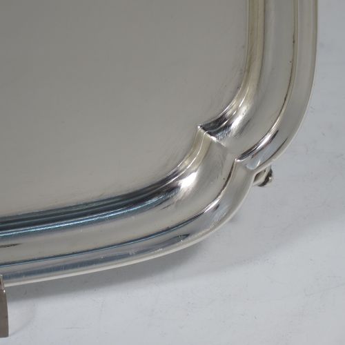 A handsome Sterling Silver salver, having a square body with shaped and cut corners, a plain burnished ground, an applied reeded border, and sitting on four cast scroll feet. Made by S. Blanckensee and Sons of Birmingham in 1934. The dimensions of this fine hand-made silver salver are 23 cms (9 inches) square, and it weighs approx. 550g (17.7 troy ounces).    