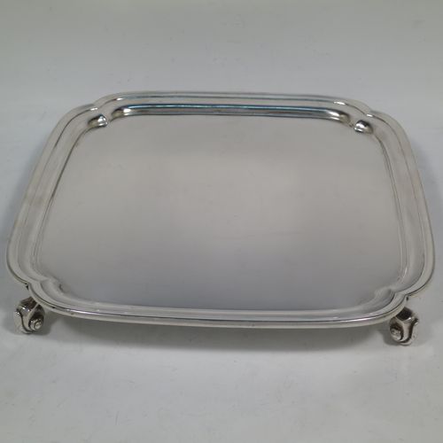 A handsome Sterling Silver salver, having a square body with shaped and cut corners, a plain burnished ground, an applied reeded border, and sitting on four cast scroll feet. Made by S. Blanckensee and Sons of Birmingham in 1934. The dimensions of this fine hand-made silver salver are 23 cms (9 inches) square, and it weighs approx. 550g (17.7 troy ounces).    