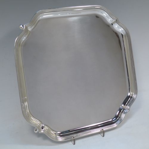 A very handsome Sterling Silver salver, having a square body with shaped and cut corners, a plain burnished ground, an applied reeded border, and sitting on four cast hoof feet. Made by Deakin Silversmiths of Sheffield in 1940. The dimensions of this fine hand-made silver salver are 26 cms (10.25 inches) square, and it weighs approx. 625g (20 troy ounces).

   