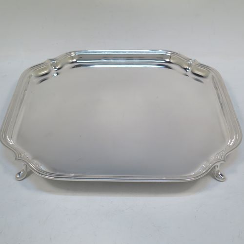 A very handsome Sterling Silver salver, having a square body with shaped and cut corners, a plain burnished ground, an applied reeded border, and sitting on four cast hoof feet. Made by Deakin Silversmiths of Sheffield in 1940. The dimensions of this fine hand-made silver salver are 26 cms (10.25 inches) square, and it weighs approx. 625g (20 troy ounces).

   