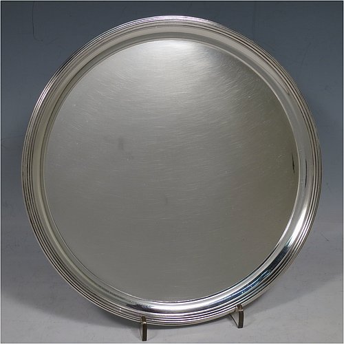 An Antique Georgian Sterling Silver very elegant George III round salver, having a plain ground, an applied reeded border, and sitting on three cast flange feet. Made by Thomas Hannam & John Crouch II of London in 1799. The dimensions of this fine hand-made antique silver salver are diameter 21 cms (8.25 inches), and it weighs approx. 404g (13 troy ounces).   