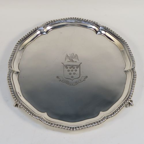 A very handsome Antique Georgian Sterling Silver salver, having an applied shaped gadroon border, a plain ground with a hand-engraved full armorial crest with a Latin inscription for Faith Is All, and sitting on three cast claw and ball feet. This elegant antique silver salver was made by John Crouch of London in 1770. The dimensions of this fine hand-made silver salver are diameter 20 cms (8 inches), and it weighs approx. 343g (11 troy ounces).   