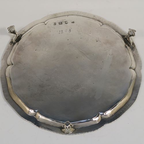 A very handsome Antique Georgian Sterling Silver salver, having an applied shaped gadroon border, a plain ground with a hand-engraved full armorial crest with a Latin inscription for Faith Is All, and sitting on three cast claw and ball feet. This elegant antique silver salver was made by John Crouch of London in 1770. The dimensions of this fine hand-made silver salver are diameter 20 cms (8 inches), and it weighs approx. 343g (11 troy ounces).   