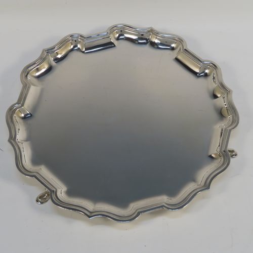 A handsome Antique Sterling Silver round salver, having a plain burnished ground, an applied Bath border, and sitting on three cast hoof feet. This elegant antique silver salver was made by Ollivant and Botsford of London in 1924. The dimensions of this fine hand-made antique silver salver are diameter 21 cms (8.25 inches), and it weighs approx. 336g (10.8 troy ounces).   