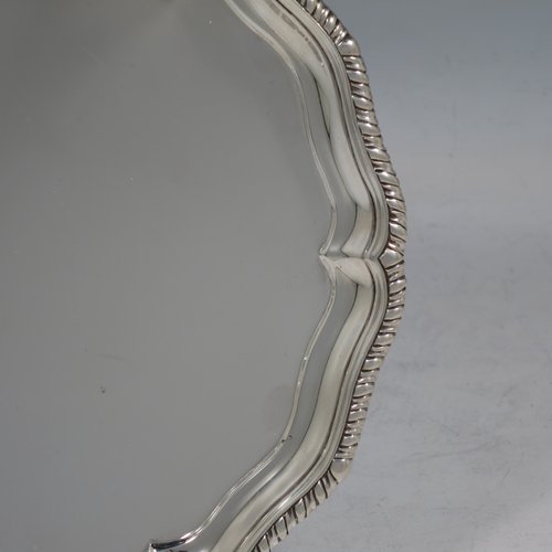 An Antique Victorian Sterling Silver salver, having a shaped gadroon border, a plain ground, and sitting on three claw and ball feet. Made by Charles Stuart Harris of London in 1888. The dimensions of this fine hand-made antique silver salver are diameter 18 cms (7 inches), and it weighs approx. 248g (8 troy ounces).    