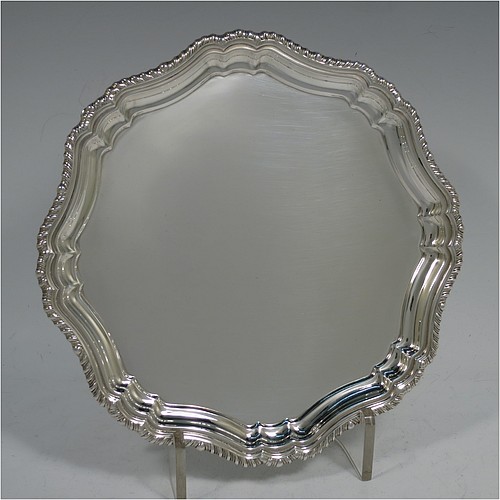 A very handsome Sterling Silver salver, having an applied shaped gadroon border, a plain ground, and sitting on four cast hoof feet. Made by William Bush of Sheffield in 1942. The dimensions of this fine hand-made silver salver are diameter 20 cms (8 inches), and it weighs approx. 375g (12 troy ounces).    