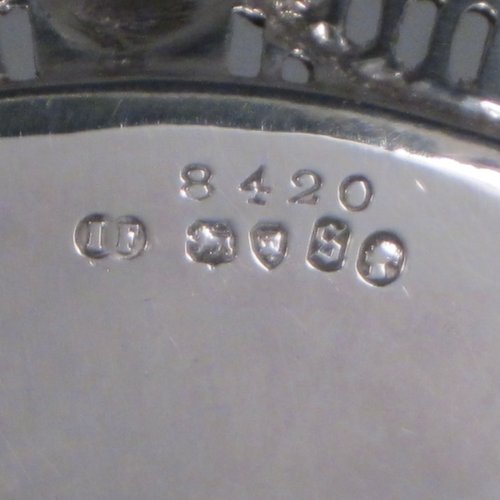 Antique Victorian sterling silver salver, having a plain ground, with an applied hand-chased and pierced border with neoclassical design showing swags, urns, portraits, and a wave-style border, and all sitting on three cast and scroll feet. Made by John Figg of London in 1873. The dimensions of this fine hand-made silver salver are diameter 18 cms (7 inches), and it weighs approx. 244g (7.8 troy ounces).   