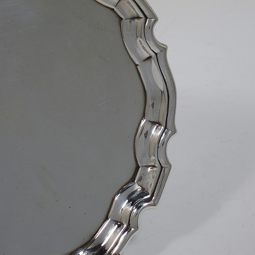 An Antique Georgian Sterling Silver George II round salver, having a plain burnished ground, an applied Chippendale border, and sitting on three cast hoof feet. Made by George Hindmarsh of London in 1736. The dimensions of this fine hand-made antique silver salver are diameter 15.5 cms (6 inches), and it weighs approx. 209g (6.7 troy ounces).    