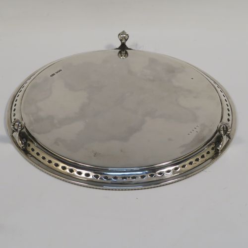 A very pretty Sterling Silver salver, having an applied bead-edged border above a hand-chased floral band, a plain ground, and sitting on three cast claw and ball feet. This beautiful silver salver was made by James Dixon and Sons of Sheffield in 1929. The dimensions of this fine hand-made silver salver are diameter 20 cms (8 inches), and it weighs approx. 307g (9.9 troy ounces).   