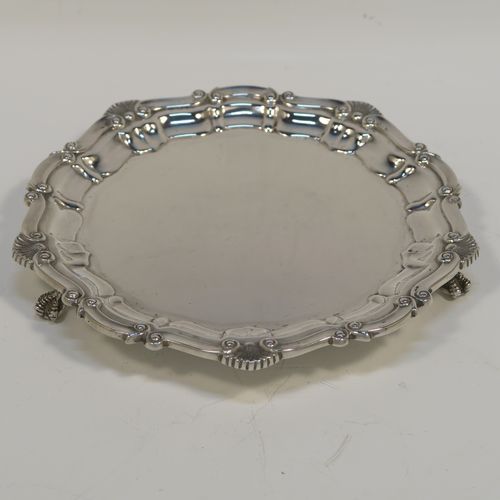 A very elegant Sterling Silver salver, having a plain burnished ground, an applied shell and scroll border, and sitting on three cast claw and ball feet. This beautiful silver salver was made by R. E. Porter of Birmingham in 1985. The dimensions of this fine hand-made silver salver are diameter 16.5 cms (6.5 inches), and it weighs approx. 206g (6.6 troy ounces).   