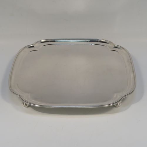 A very handsome Sterling Silver salver, having a square body with an applied cut-corner border, a plain ground, and sitting on four cast scroll feet. This elegant silver salver was made by Josiah Williams and Co., of London in 1939. The dimensions of this fine hand-made silver salver are 19 cms (7.5 inches) square, and it weighs approx. 302g (9.7 troy ounces).   