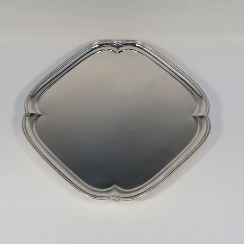 A very handsome Sterling Silver salver, having a square body with an applied cut-corner border, a plain ground, and sitting on four cast scroll feet. This elegant silver salver was made by Josiah Williams and Co., of London in 1939. The dimensions of this fine hand-made silver salver are 19 cms (7.5 inches) square, and it weighs approx. 302g (9.7 troy ounces).   