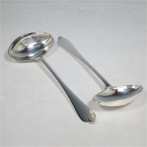 A Sterling Silver pair of Sauce Ladles in the plain Dog-nose pattern with Rattail on reverse, and oval bowls. Made by Goldsmiths & Silversmiths of London in 1917. The dimensions of this fine pair of hand-made silver sauce ladles are length 18 cms (7 inches), and they weigh a total of approx. 155g (5 troy ounces).    