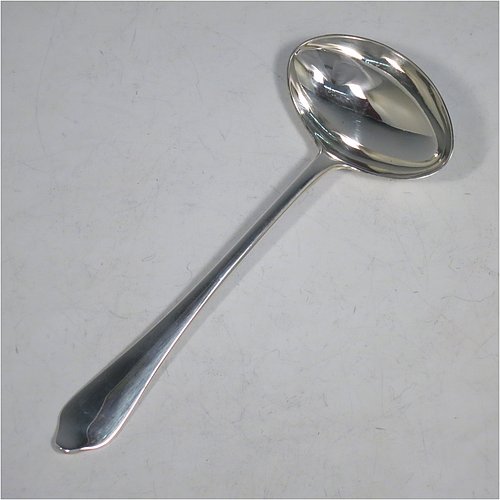 A Sterling Silver pair of Sauce Ladles in the plain Dog-nose pattern with Rattail on reverse, and oval bowls. Made by Goldsmiths & Silversmiths of London in 1917. The dimensions of this fine pair of hand-made silver sauce ladles are length 18 cms (7 inches), and they weigh a total of approx. 155g (5 troy ounces).    