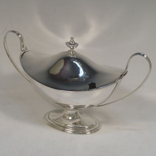 A very elegant Sterling Silver pair of sauce tureens with covers, having plain oval neoclassical boat-shaped bodies with applied reeded borders, pull-off lids with cast finials,  with reeded loop side-handles, and all sitting on pedestal feet. These beautiful silver sauce tureens were made by Thomas Bradbury of Sheffield in 1931. The dimensions of this fine hand-made silver2 pair of sauce tureens are height 13.5 cms (5.5 inches), length 23 cms (9 inches), width 10 cms (4 inches), with a total weight of approx. 853g (27.5 troy ounces).    