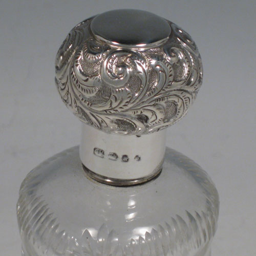 Antique Victorian sterling silver and hand-cut crystal pair of very unusual Glug-Glug scent bottles, made by George Maudsley of Birmingham in 1894. Height 15 cms (6 inches), width 5 cms (2 inches).